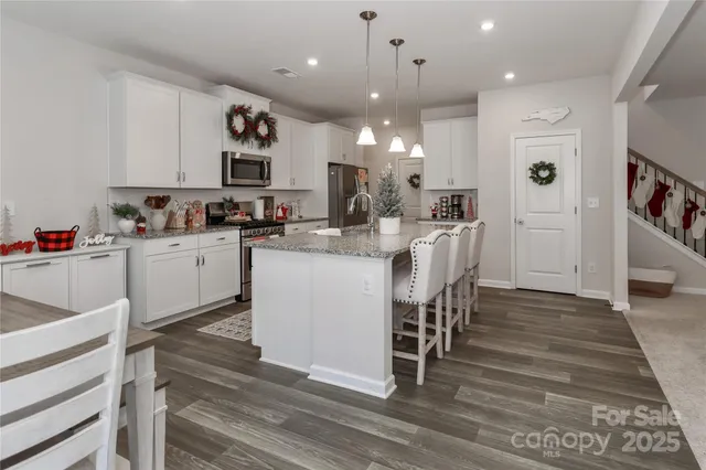 a kitchen with a sink appliances and cabinets