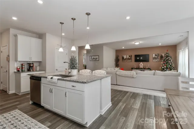 a kitchen with stainless steel appliances granite countertop a refrigerator sink and cabinets