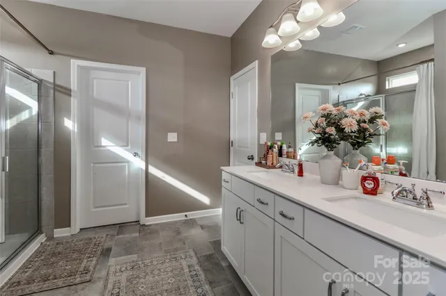 a bathroom with a glass shower door