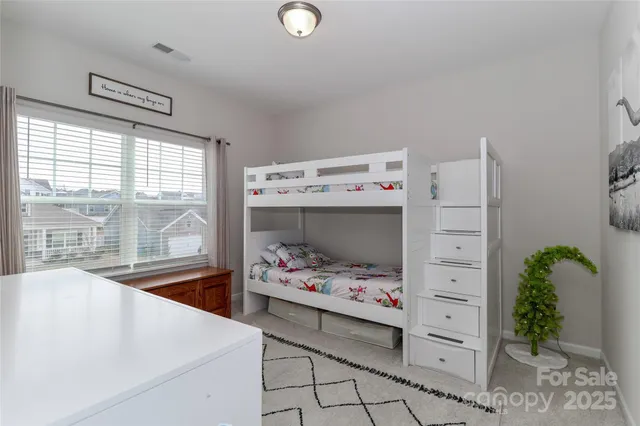 a utility room with cabinets and wooden floor