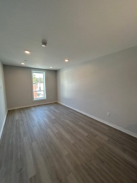 148 Old Post Road, Unit 216 Sharon, MA 02067 - Photo 15 of 22 an empty room with wooden floor and windows