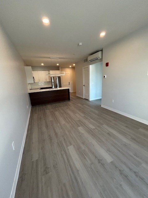 148 Old Post Road, Unit 216 Sharon, MA 02067 - Photo 2 of 22 wooden floor in an empty room with a window