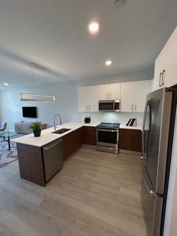 148 Old Post Road, Unit 216 Sharon, MA 02067 - Photo 3 of 20 a kitchen with stainless steel appliances granite countertop a refrigerator and a sink