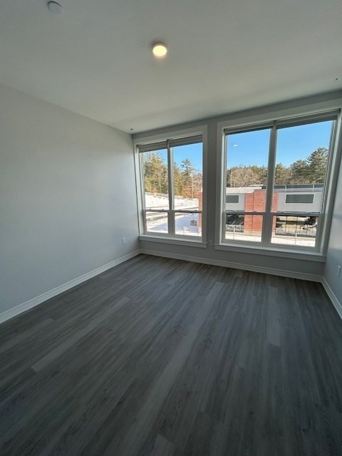 148 Old Post Road, Unit 216 Sharon, MA 02067 - Photo 4 of 22 wooden floor in an empty room with a window