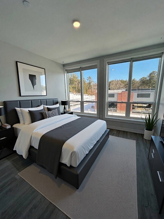 148 Old Post Road, Unit 216 Sharon, MA 02067 - Photo 5 of 20 a bedroom with a large bed and a large window