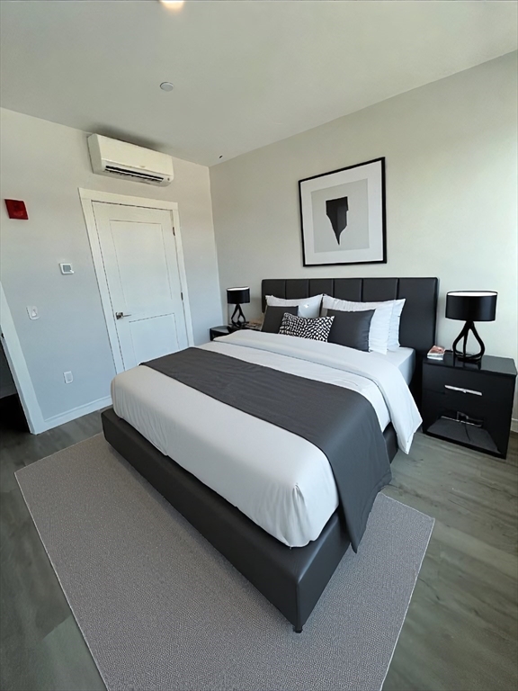 148 Old Post Road, Unit 216 Sharon, MA 02067 - Photo 6 of 20 a bedroom with a bed and a night stand