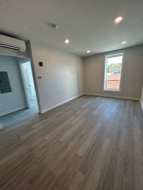148 Old Post Road, Unit 216 Sharon, MA 02067 - Photo 6 of 22 an empty room with wooden floor and windows