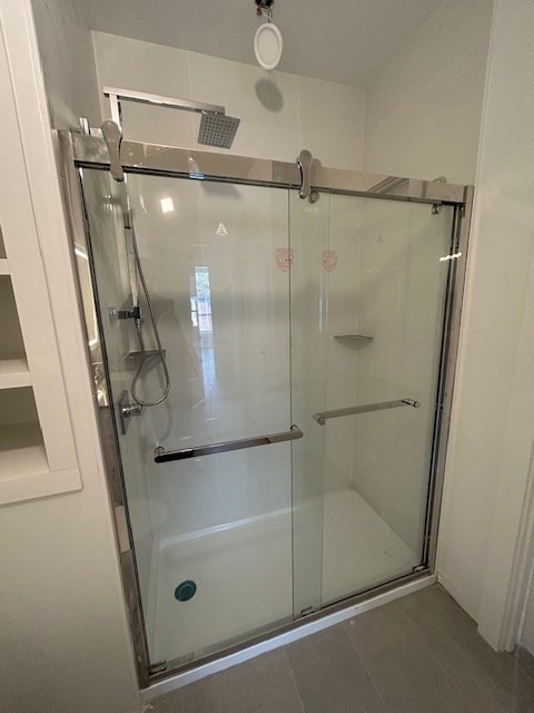 148 Old Post Road, Unit 216 Sharon, MA 02067 - Photo 8 of 20 a bathroom with a glass shower door