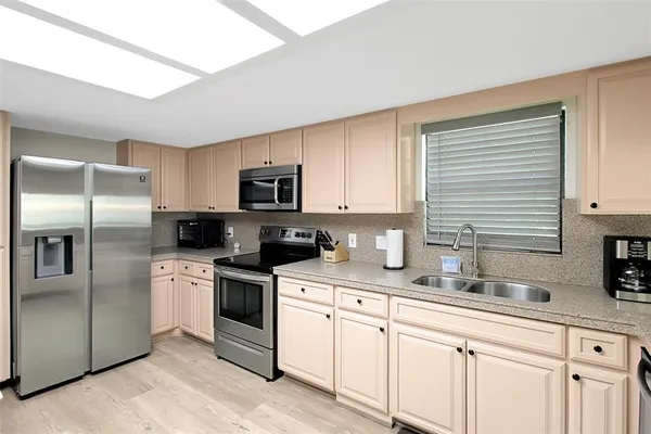 a kitchen with a sink stove and microwave