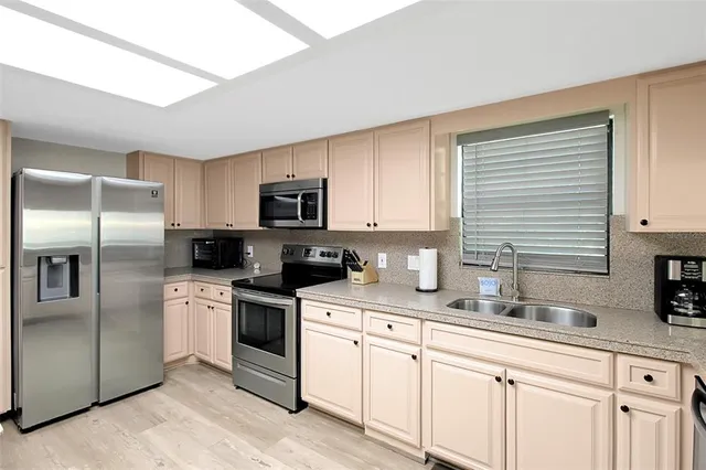 a kitchen with a sink stove and microwave
