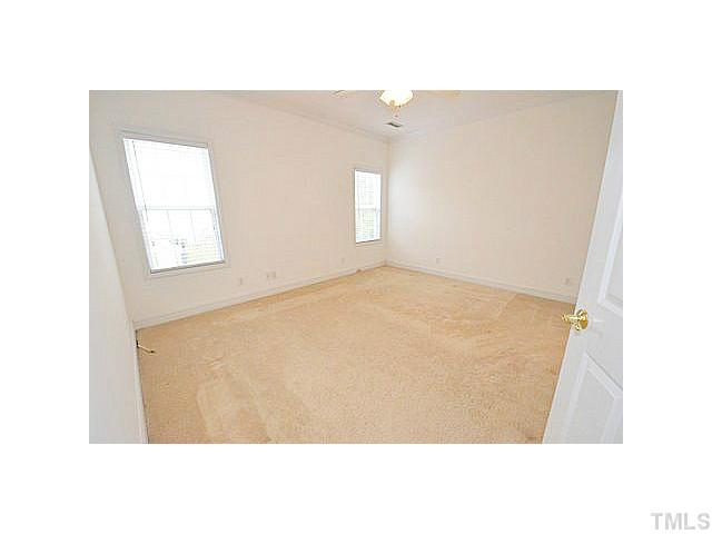 201 Reedhaven Drive Cary, NC 27513 - Photo 8 of 20 First floor master bedroom with crown molding, ceiling fan, and walk-in closet.