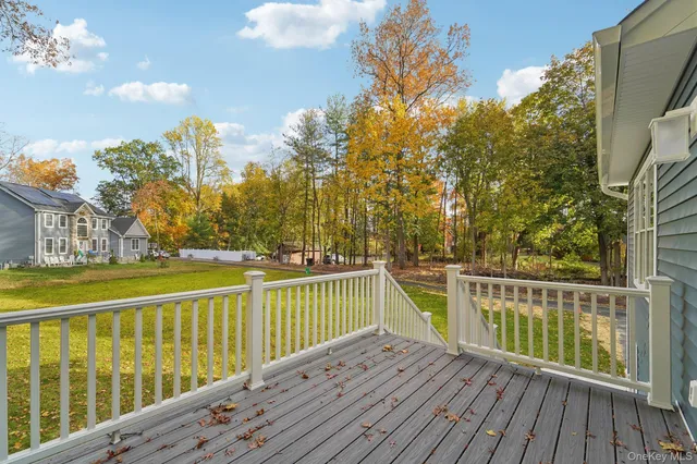 a view of balcony with wooden floor and fence