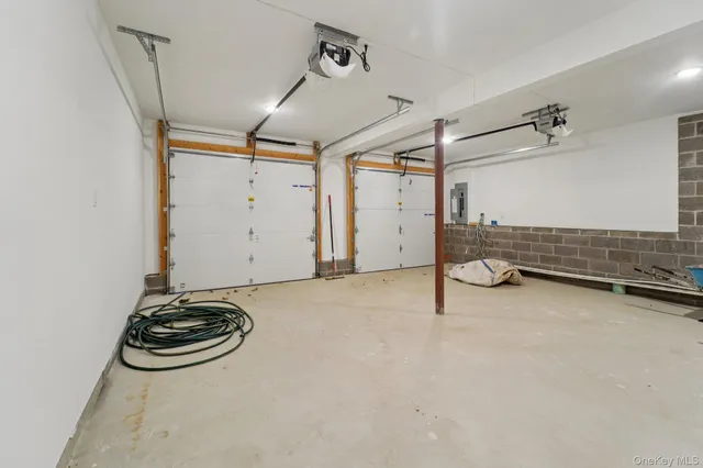 a view of a storage and utility room with two washing machine