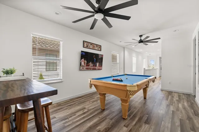 a living room with table chairs and a window