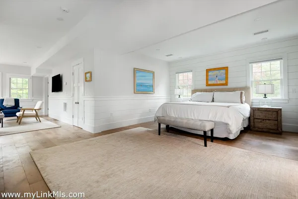 a spacious bedroom with a bed and a window