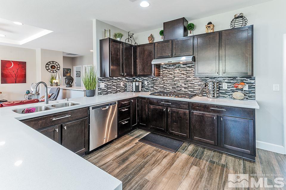 512 Alpine Rose Ct. Reno, NV 89521 - Photo 6 of 17 a kitchen with stainless steel appliances granite countertop a sink stove and refrigerator