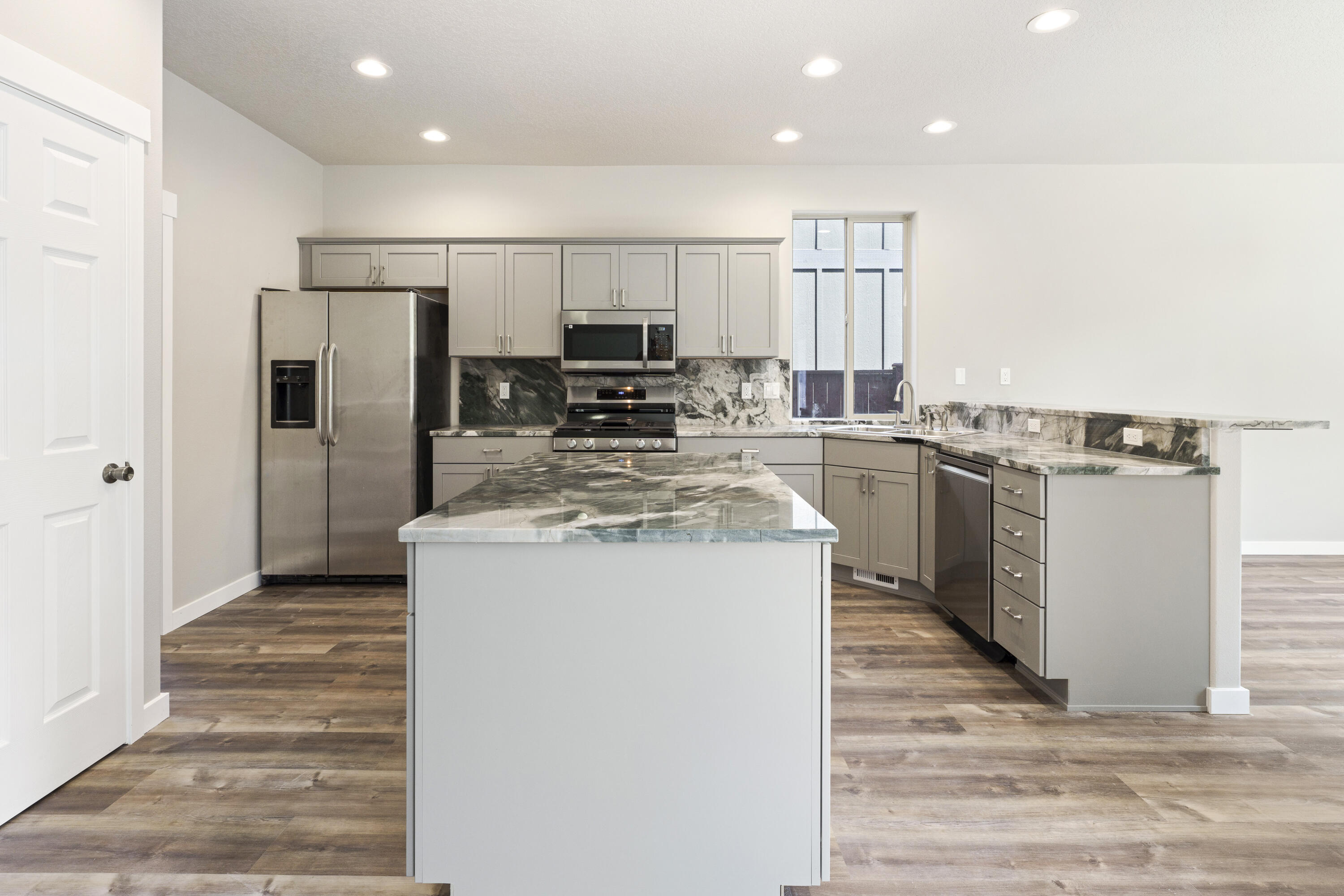 21189 Ritz Place Bend, OR 97702 - Photo 5 of 37 a kitchen with appliances a sink and counter top space