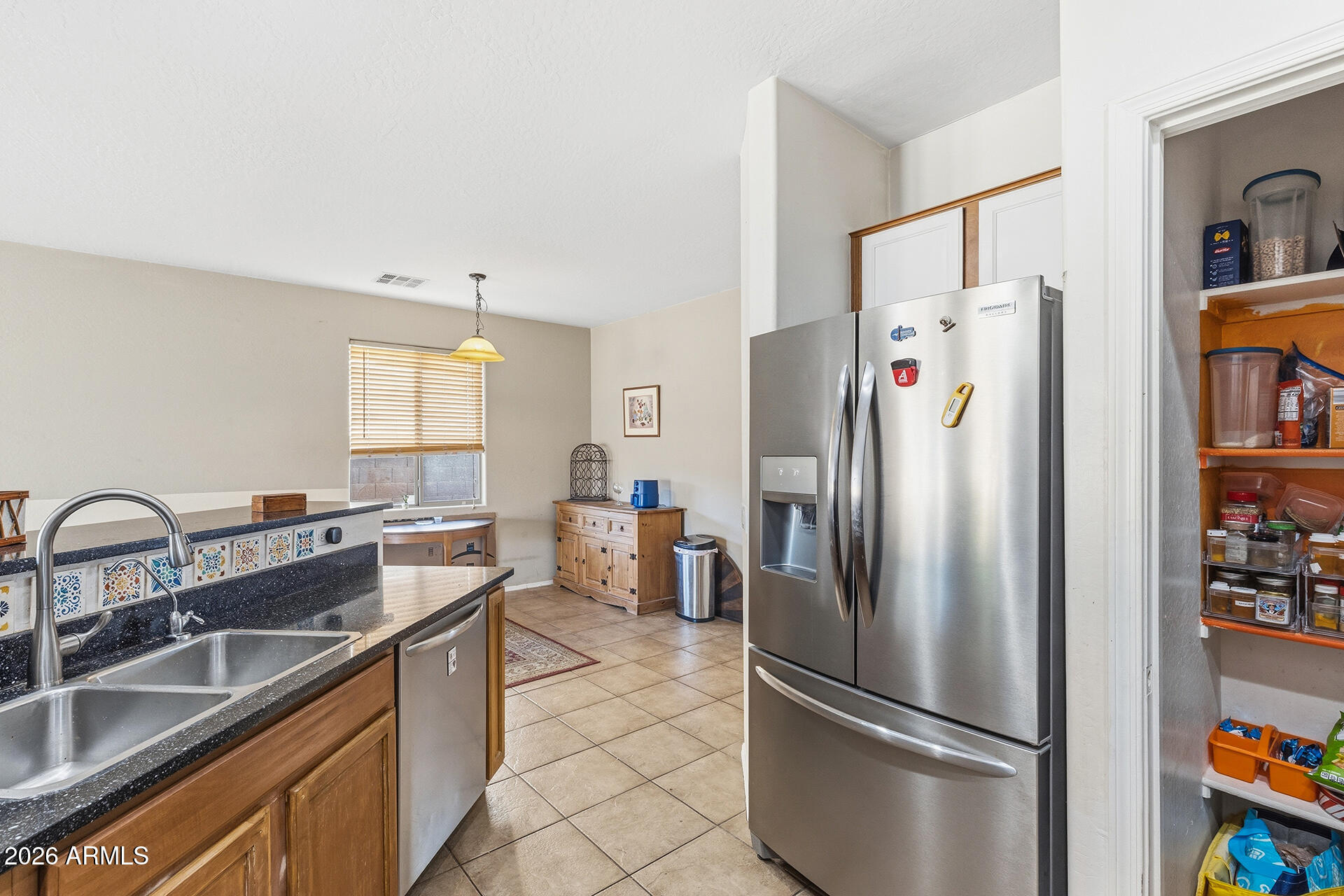 6718 West Darrel Road Laveen, AZ 85339 - Photo 36 of 49 a kitchen with stainless steel appliances granite countertop a refrigerator and a sink