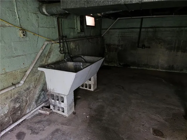 a white bath tub sitting in a bathroom next to a sink