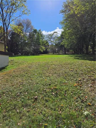 a view of field with trees in the background