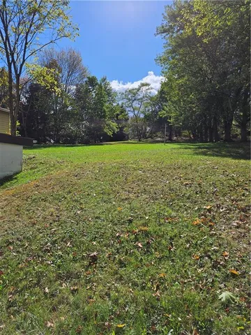 a view of field with trees in the background