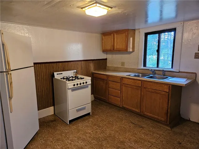a kitchen with stainless steel appliances a refrigerator sink and stove