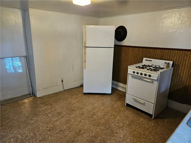 a view of a storage and utility room with a stove