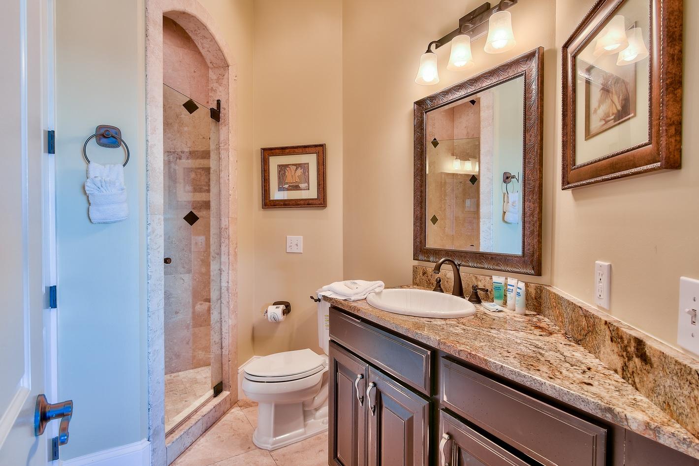 72 South Wall Street Inlet Beach, FL 32461 - Photo 24 of 27 a bathroom with a granite countertop toilet a sink and a mirror