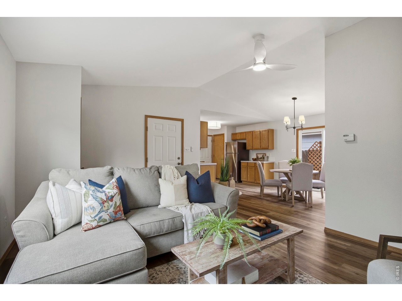 a living room with furniture and wooden floor