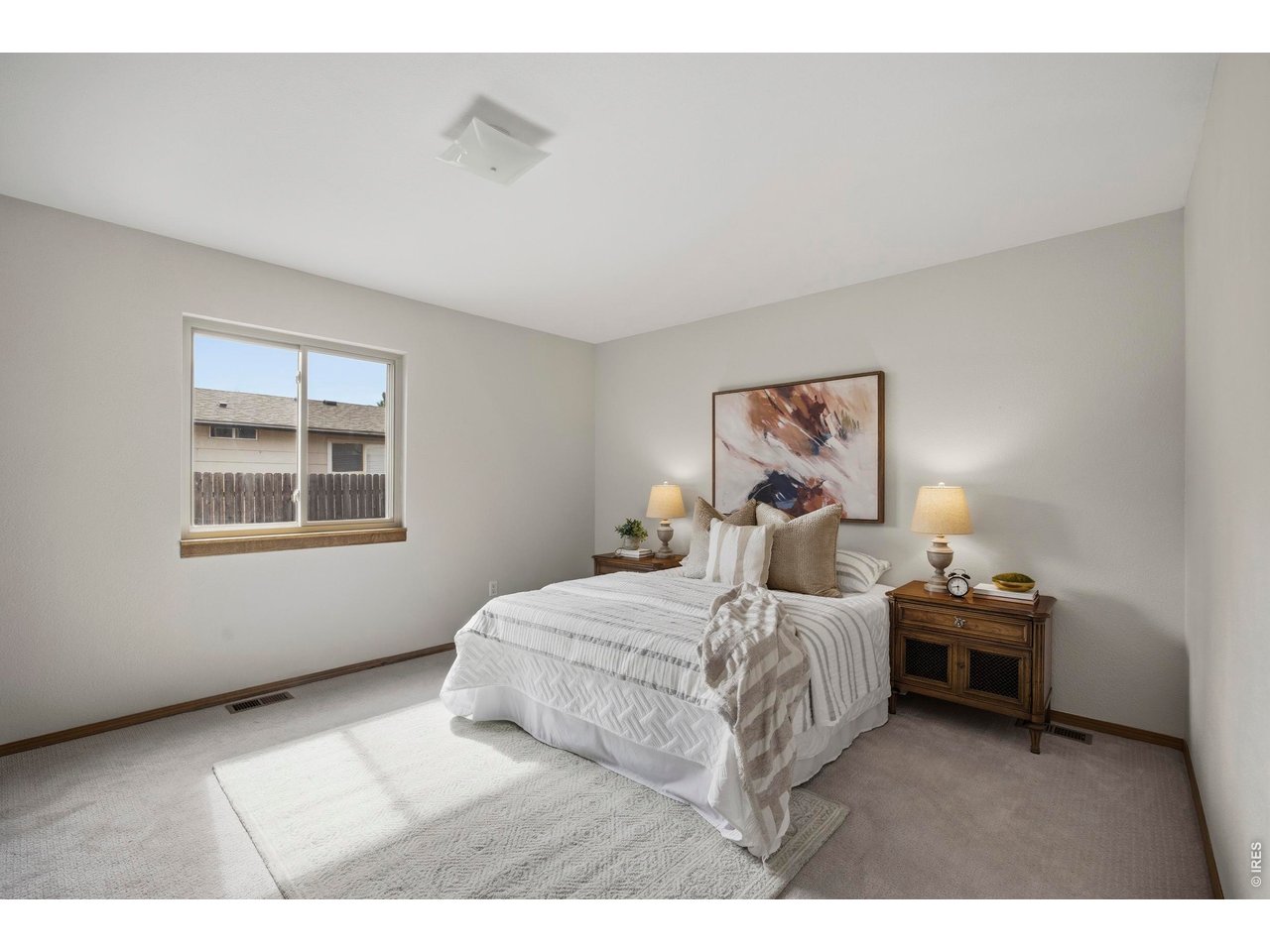1225 Alameda Street Fort Collins, CO 80521 - Photo 12 of 32 a bedroom with a bed and a painting on the wall