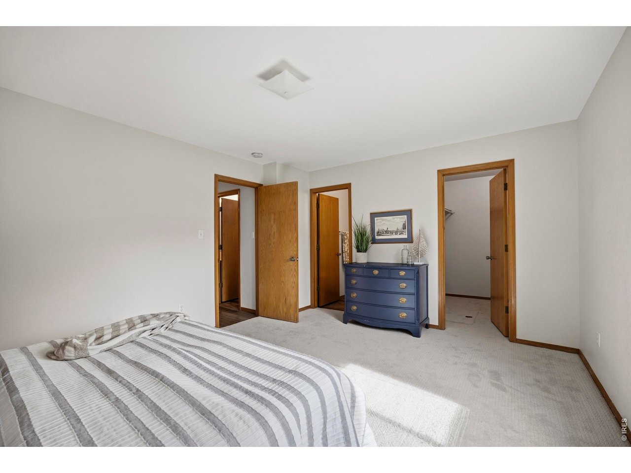 1225 Alameda Street Fort Collins, CO 80521 - Photo 13 of 32 a bedroom with a bed and wooden floor