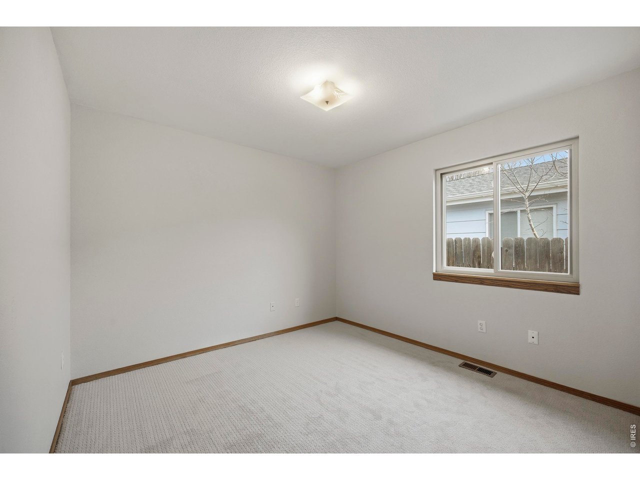 1225 Alameda Street Fort Collins, CO 80521 - Photo 18 of 32 a view of an empty room with a window