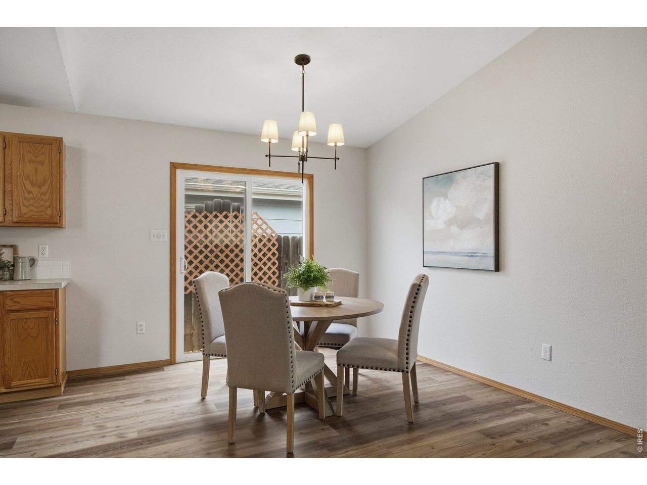 1225 Alameda Street Fort Collins, CO 80521 - Photo 7 of 32 a dining room with furniture a chandelier and wooden floor