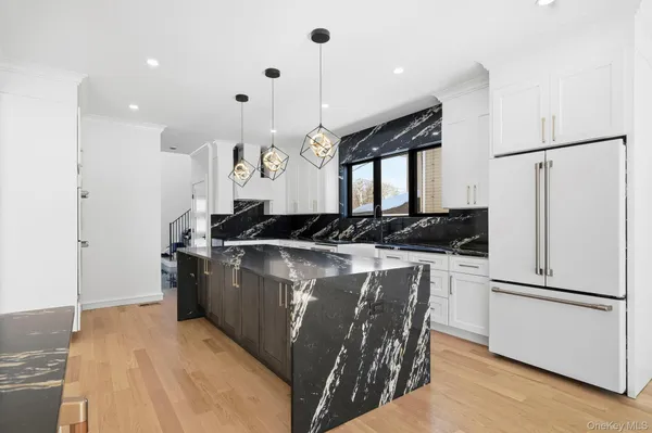 a kitchen with a stove a refrigerator and a sink