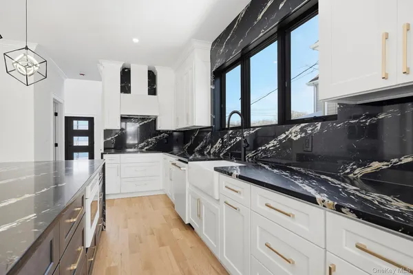 a kitchen with granite countertop a stove and a sink