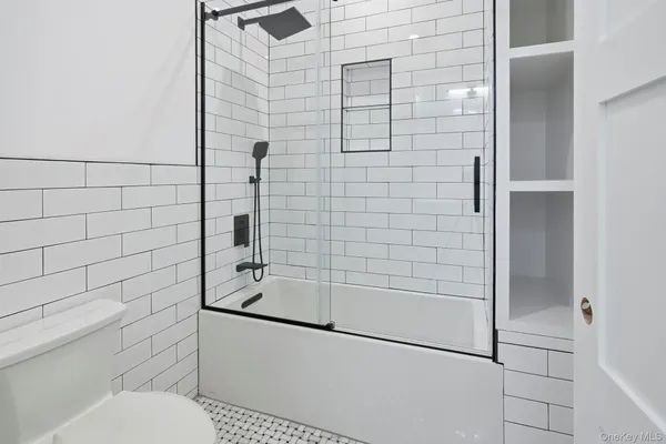 a bathroom with a shower and toilet