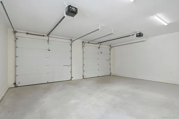 an empty room with chandelier fan