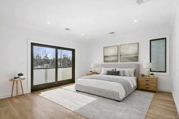 a bedroom with a large bed and a large window