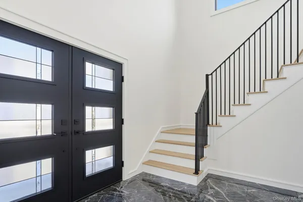 a view of entryway and hall with wooden floor