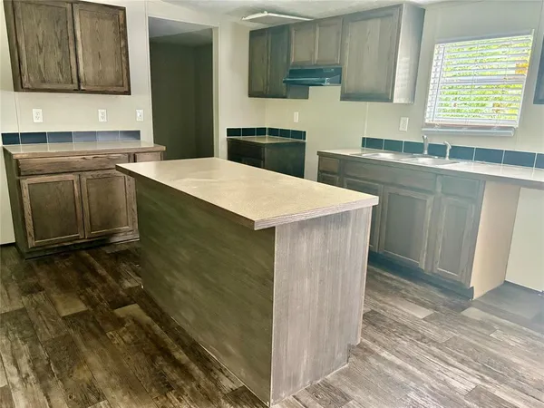 a kitchen with a sink cabinets and window