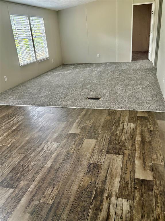 437 Maple Drive Murchison, TX 75778 - Photo 6 of 6 an empty room with wooden floor and windows