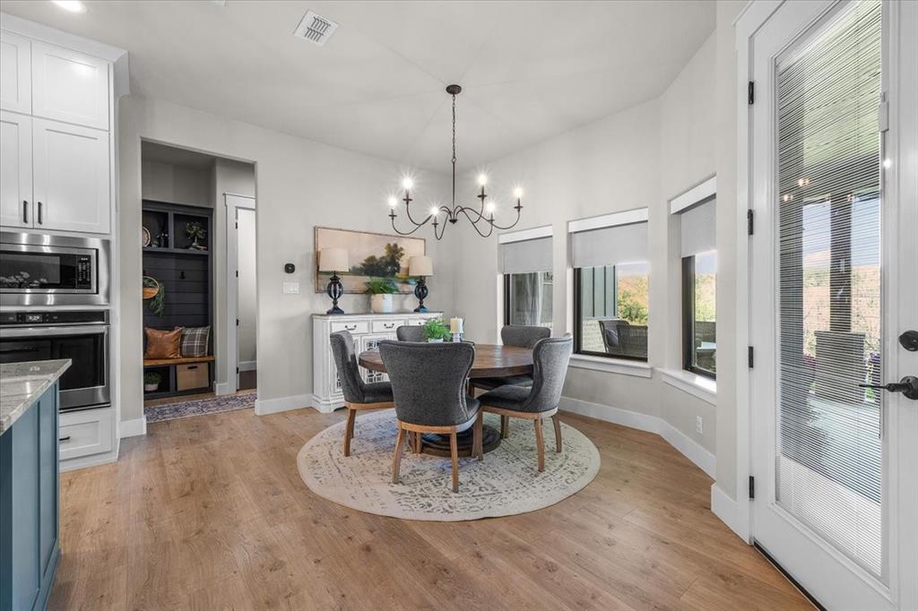 1059 Sweeney Way Weatherford, TX 76087 - Photo 5 of 37 Dining area featuring a contemporary chandelier and plenty of natural light.