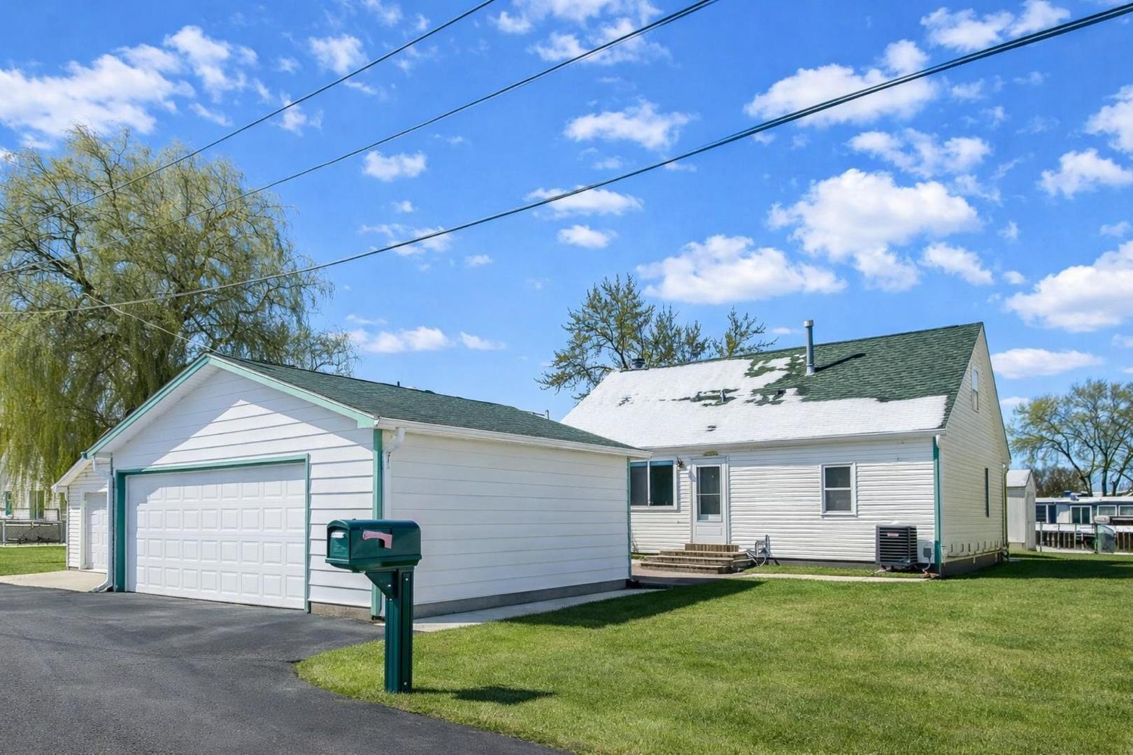 a view of a house with a yard and sitting area