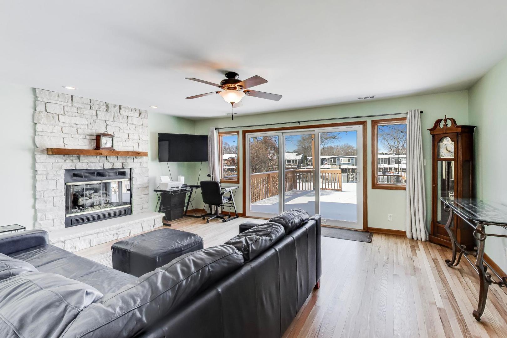 37464 North Terrace Lane Spring Grove, IL 60081 - Photo 2 of 40 a living room with furniture flat screen tv and a fireplace