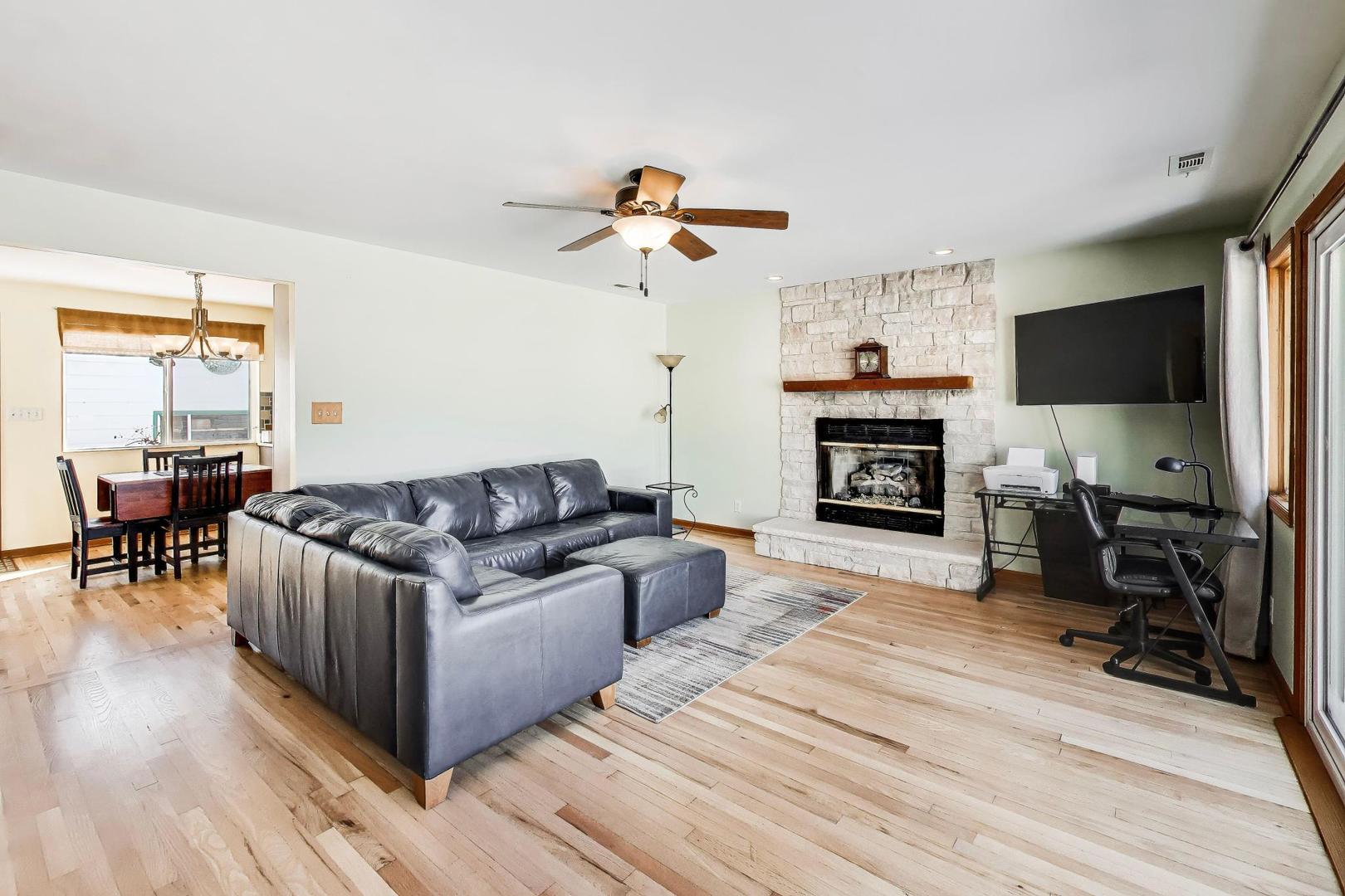 37464 North Terrace Lane Spring Grove, IL 60081 - Photo 3 of 40 a living room with furniture a fireplace and a flat screen tv