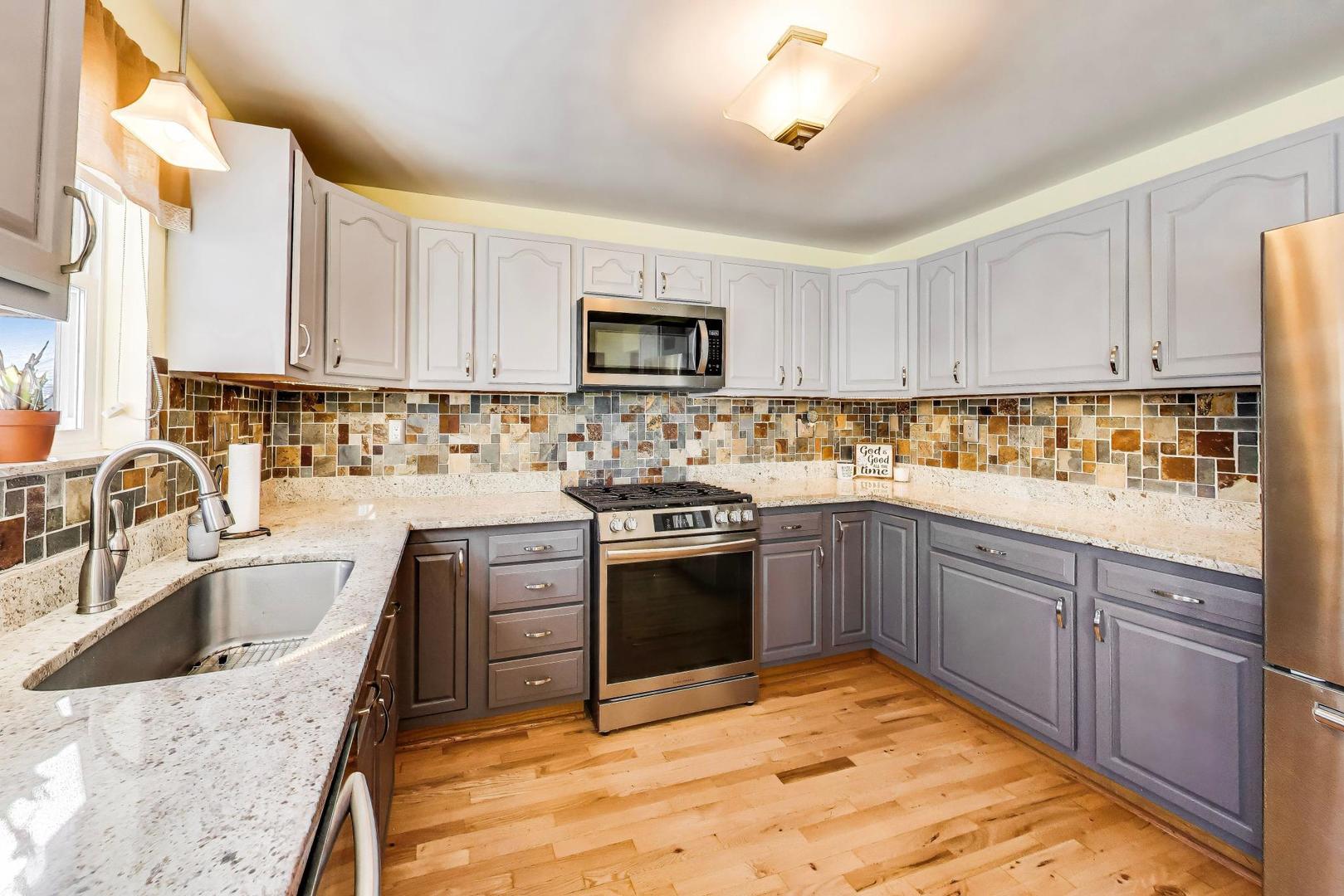 37464 North Terrace Lane Spring Grove, IL 60081 - Photo 8 of 40 a kitchen with stainless steel appliances granite countertop a sink stove and refrigerator