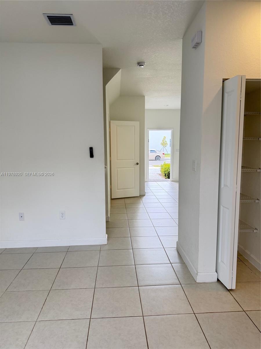 17953 Southwest 359th Street Homestead, FL 33034 - Photo 16 of 36 a view of a refrigerator in kitchen and an empty room