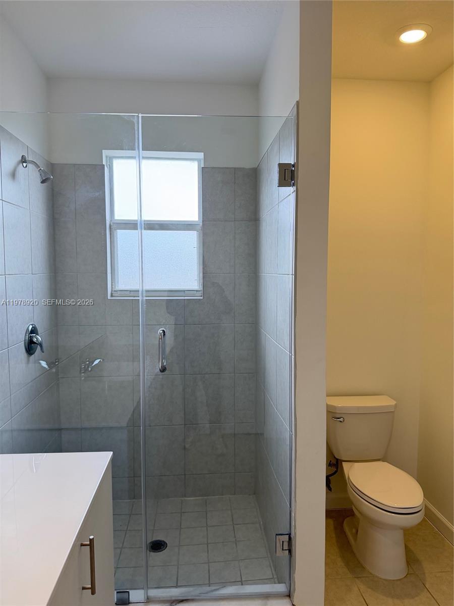 17953 Southwest 359th Street Homestead, FL 33034 - Photo 25 of 36 a bathroom with a shower a toilet and a sink