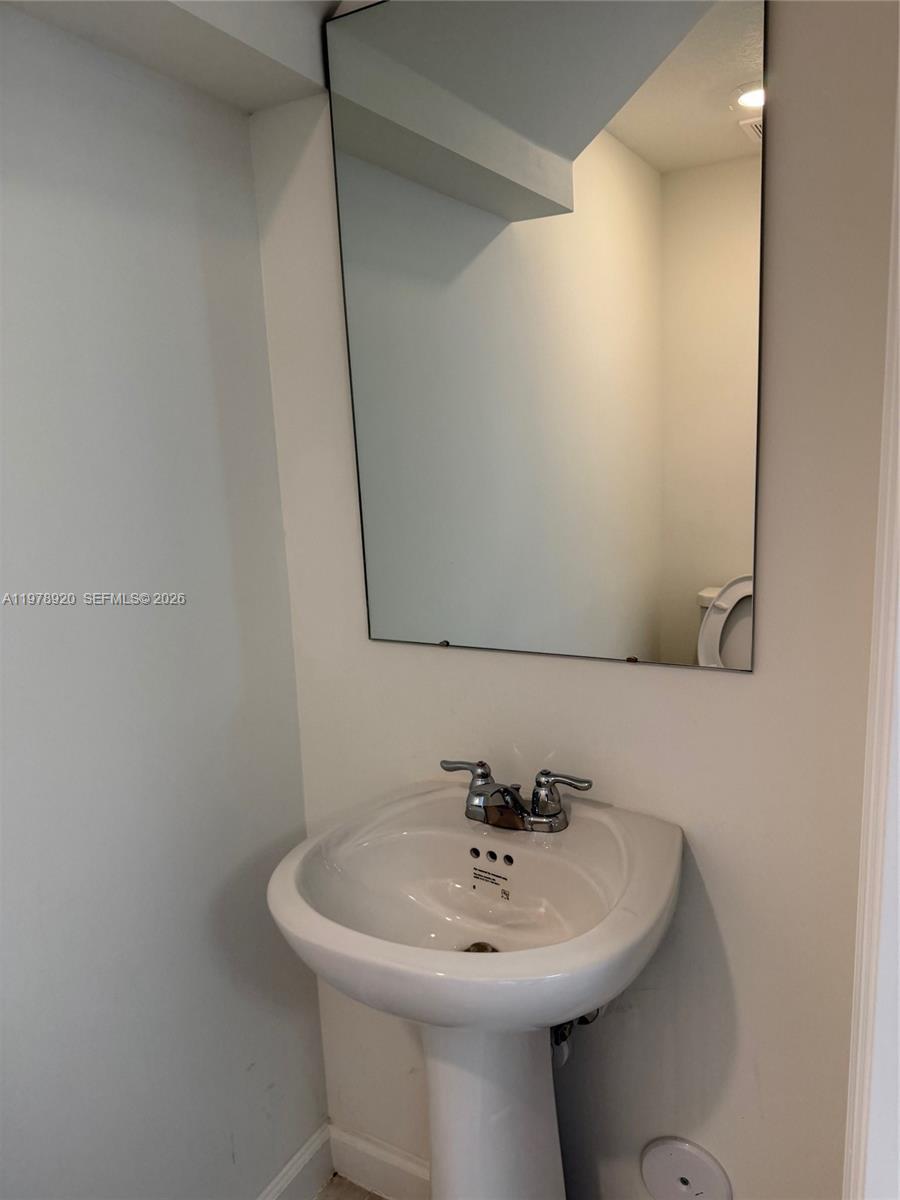 17953 Southwest 359th Street Homestead, FL 33034 - Photo 10 of 36 a bathroom with a sink and mirror