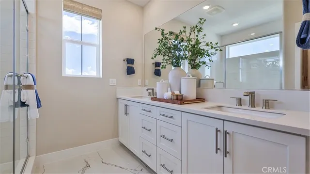 a bathroom with a granite countertop sink a mirror a and window
